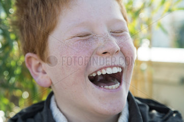 Boy laughing with eyes closed  portrait