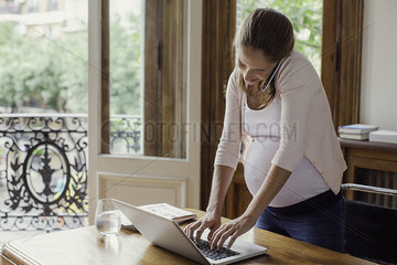 Pregnant woman working from home