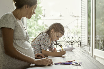 Mother and daughter coloring together