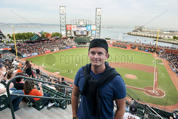 Man standing in baseball stadium in San Francisco  California  USA
