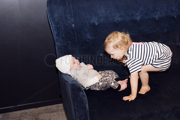 Toddler playing with infant sibling
