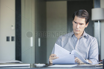 Man reading document in office