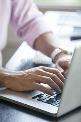 Man using laptop computer  cropped