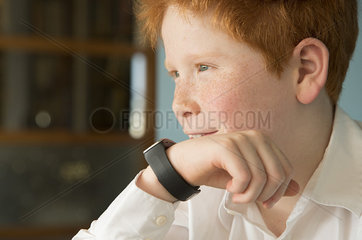 Boy speaking into smartwatch