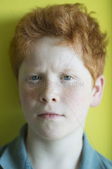 Boy with red hair furrowing brow  portrait