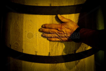 Hand touching wooden cask