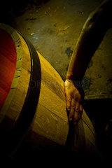 Hand touching wooden cask