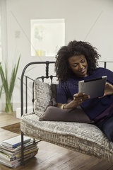 Woman streaming online video content on digital tablet