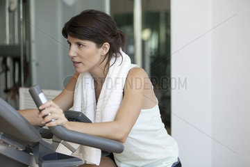 Woman working out on fitness machine