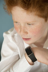 Boy speaking into smartwatch