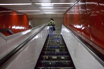 Berlin  Frau faehrt auf einer Rolltreppe