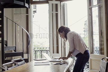 Woman using laptop computer at home