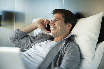 Man talking on cell phone  smiling cheerfully