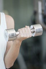 Woman lifting dumbbell  cropped