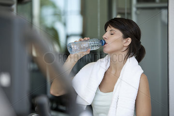 Woman drinking bottled water after a workout