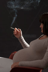 Freiburg  Deutschland  eine schwangere Frau mit einer brennenden Zigarette