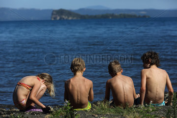 Bolsena  Italien  Kinder sitzen am Ufer des Bolsenasee