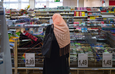 Berlin  Deutschland  eine Frau mit Kopftuch in einem Geschaeft