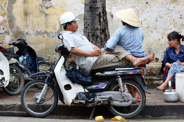Vietnam  Ein Mann sitzt auf seinem Motorrad