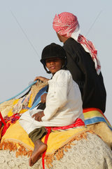 Ein Kind reitet auf einem Kamel  Dubai