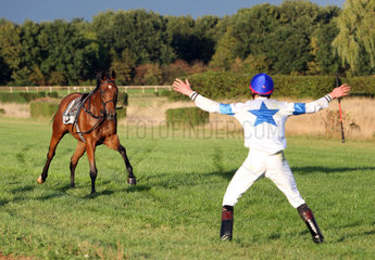 Hannover  Deutschland  Jockey versucht sein reiterloses Pferd aufzuhalten