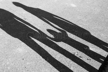 Shadow of parents and child holding hands