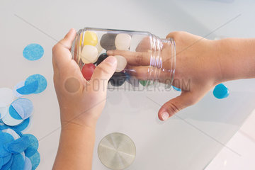 Child reaching into candy jar  cropped