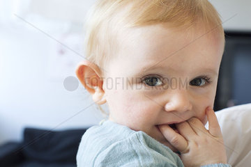 Baby chewing on fingers  portrait