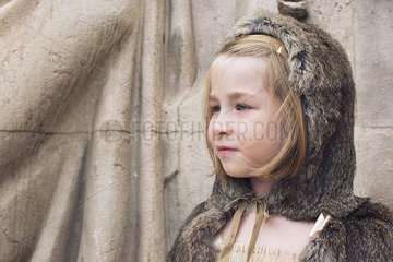 Little girl wearing hooded fur cloak outdoors  portrait