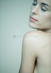 Woman with bare shoulder  eyes closed  portrait