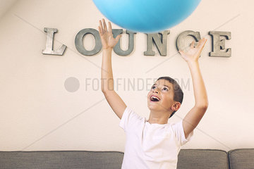 Boy catching large ball