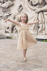 Little girl dancing outdoors