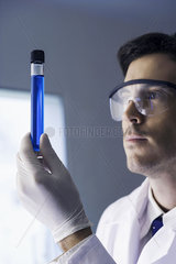 Researcher examining test tube in laboratory