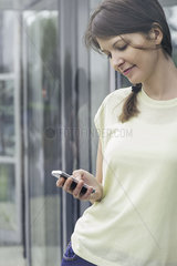 Woman text messaging with smartphone