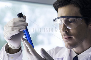 Scientist examining test tube in laboratory