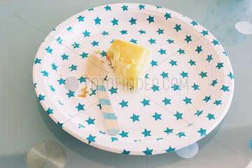 Partially eaten piece of cake on festive paper plate