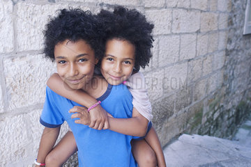 Young siblings embracing outdoors  portrait
