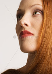 Woman with red hair  wearing lipstick  portrait