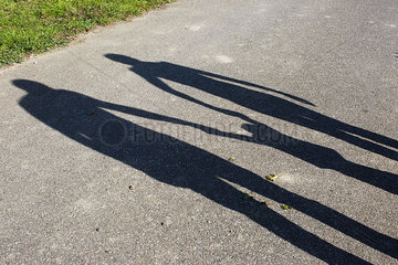 Shadow of a family holding hands outdoors