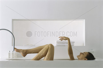 Woman relaxing in bath  side view
