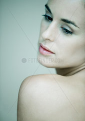 Woman looking over bare shoulder  portrait