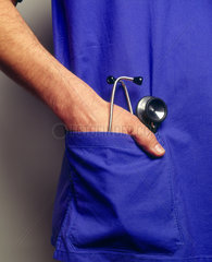 Hand eines Mediziners und ein Stethoskop in der Kitteltasche