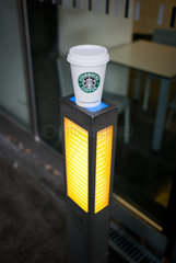 Berlin  Deutschland  ein Starbucks Pappbecher steht auf einer Lampe