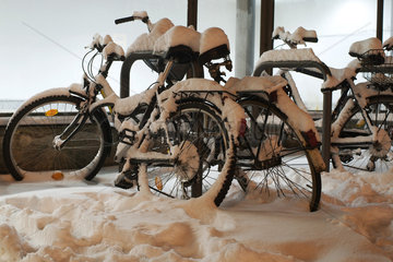 Berlin  Deutschland  vom Schnee bedeckte Fahrraeder am Bahnhof Lichtenberg