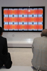 Berlin  Deutschland  Besucher auf der IFA schauen auf einen grossen Flachbildschirm