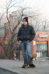 Bremen  Deutschland  Jugendlicher mit Skateboard am Rand einer Halfpipe