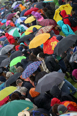 Hoppegarten  Deutschland  Menschen stehen bei Schlechtwetter unter ihren Regenschirmen