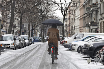 Radfahrer mit Regenschirm