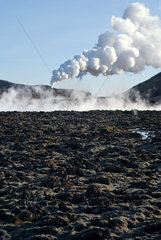 Island  Blick ueber ein Lavafeld auf das Geothermalkraftwerk bei Grindavik