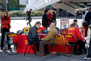 Berlin  Deutschland  Menschen am Stand von Scientology am Alexanderplatz